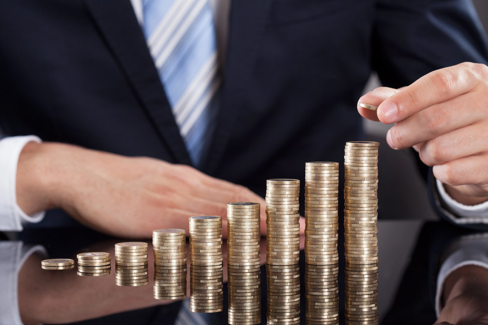 Businessman putting coins at the table