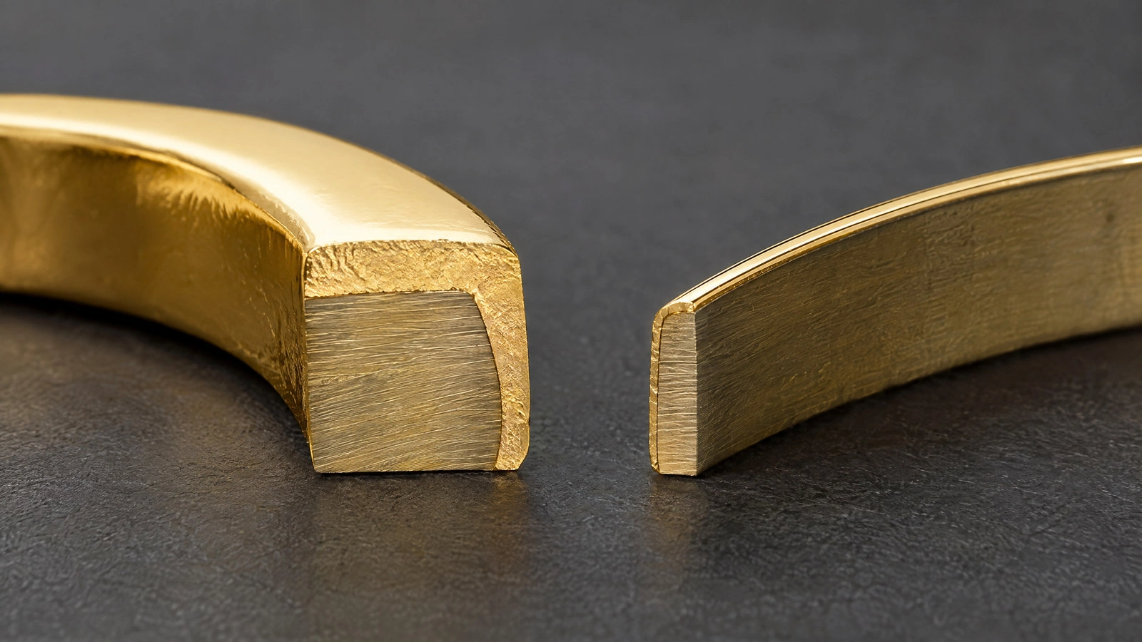 Conceptual cutaway comparing a substantial bonded gold layer with a much thinner electroplated surface over base metal.