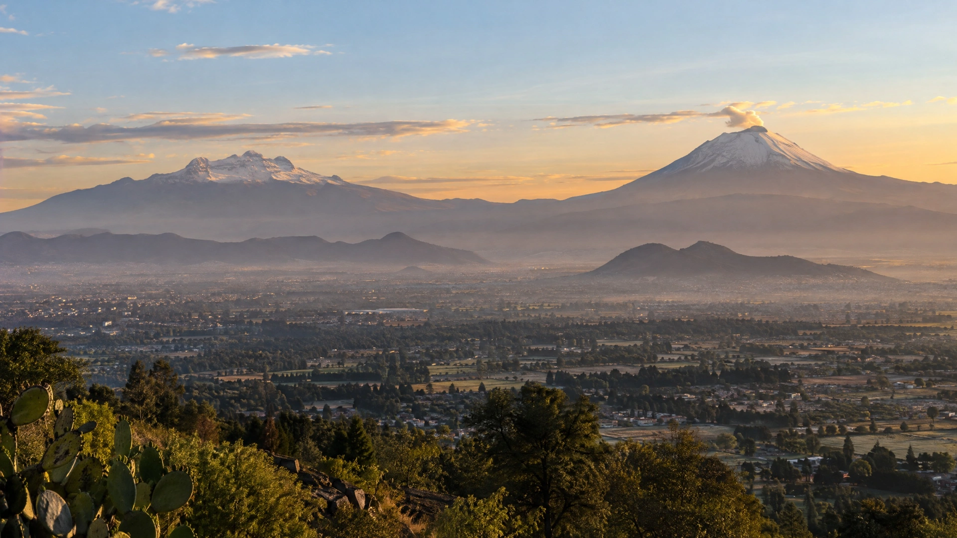 Popocatépetl and Iztaccíhuatl viewed across the Valley of Mexico in morning light.
